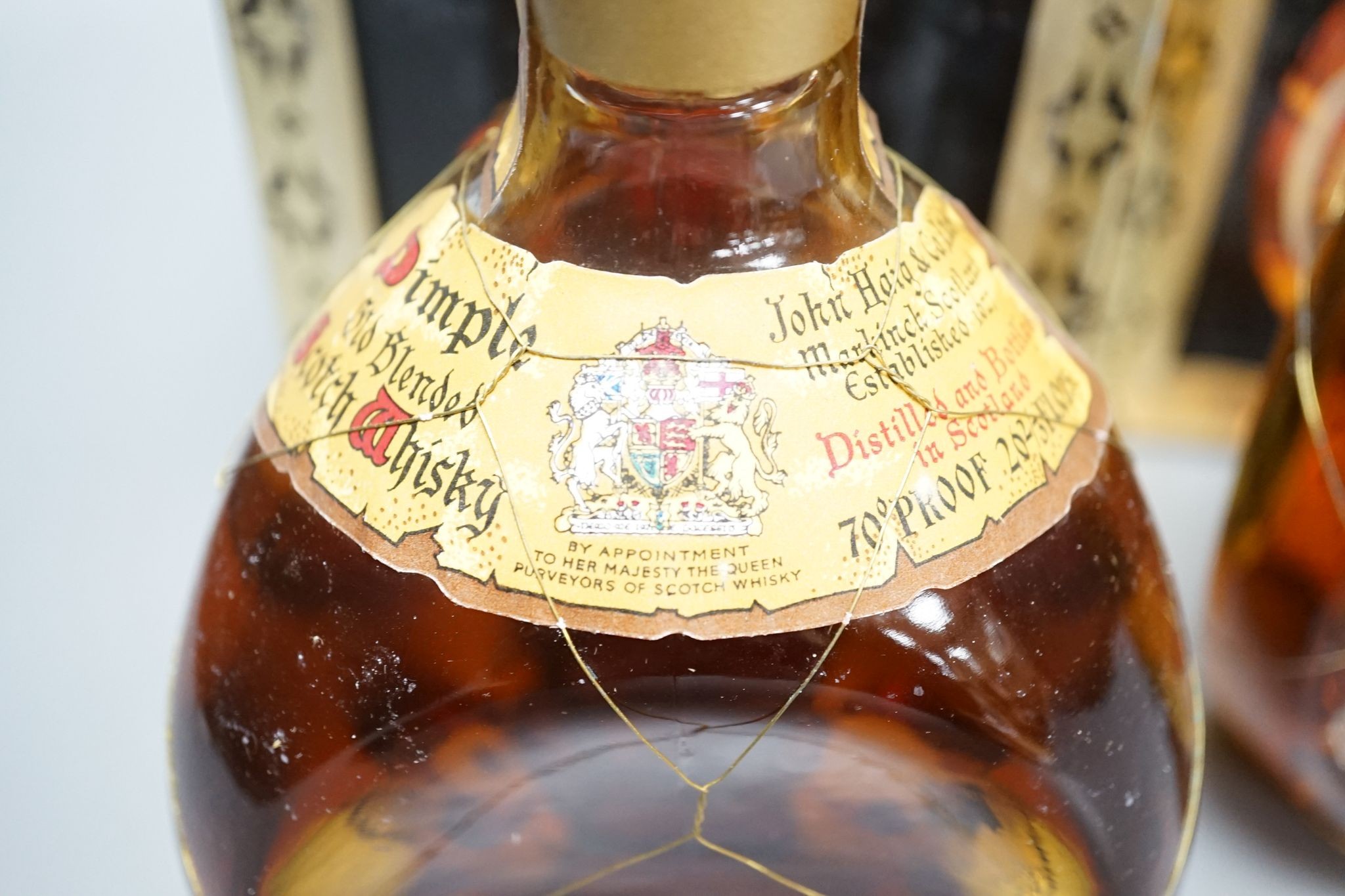 Two boxed bottles of Dimple Scotch whisky.